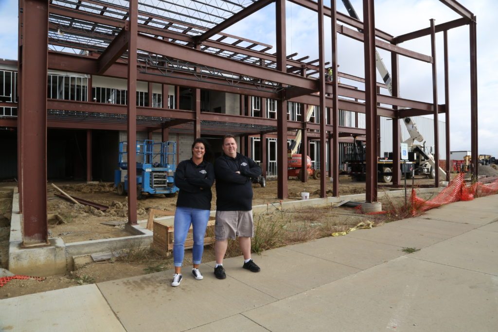 Lacy and Bill stand in front of the new Clickstop Building Construction