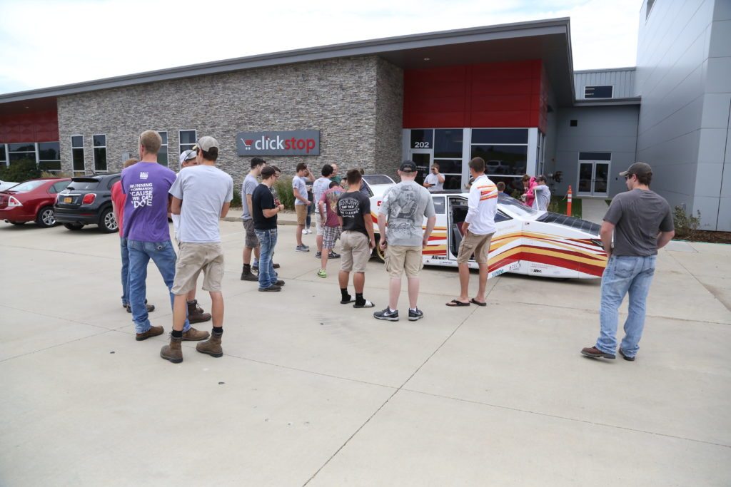 Clickstoppers and community members gather to check out the solar car.