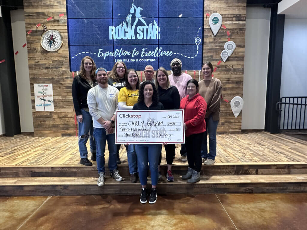 Photo of award winners from Clickstop's Rock Star Reveal event on January 25. Photo includes, Jamie Farmer, Mike Staebell, Rhonda Daisy, Dee Swayze, Sara Wilkins, Brian Brinkema, Kendra Wolff, Lindsey Begemann, Sara Alden, and Carly Grimm.