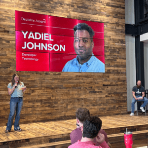 VP of Technology Kara Oehlerich announcing to a room of employees that Yadiel Johnson as the Q1 Decisive Award Winner.