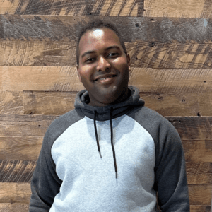 Photo of Yadiel Johnson with a Wooden Panel Backdrop